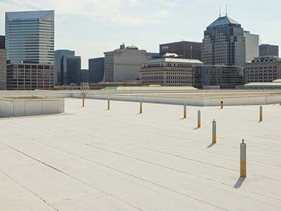 Flat commercial rooftop with a city landscape in the background
