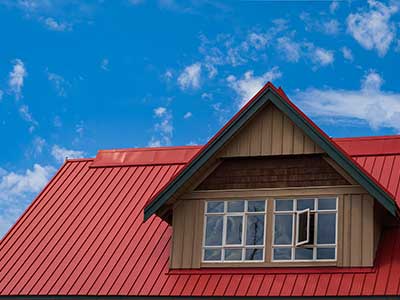 Close up of a red metal roof on a home